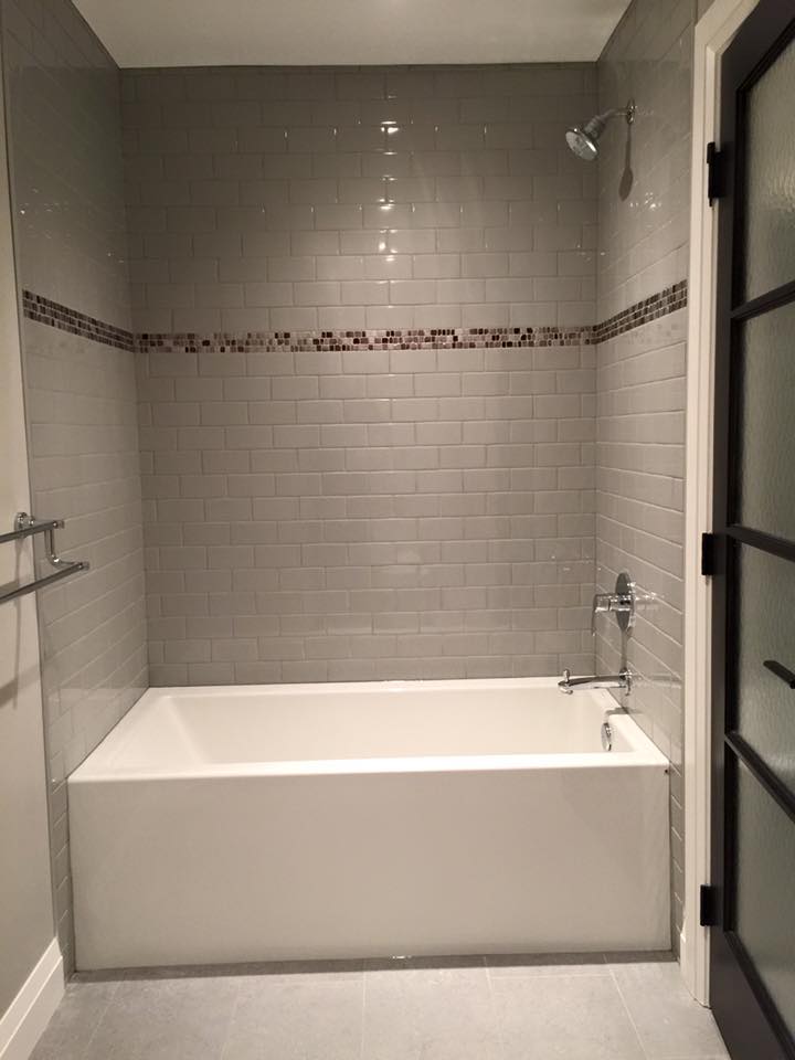 jack and Jill bath tub shower in 3x6 subway with accent tile at eye level