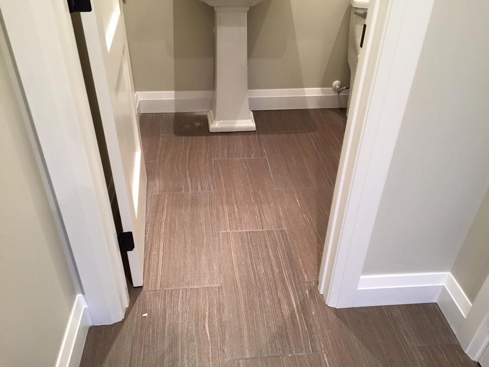 powder room as you enter pass the mudroom all in the same 12x24 tile