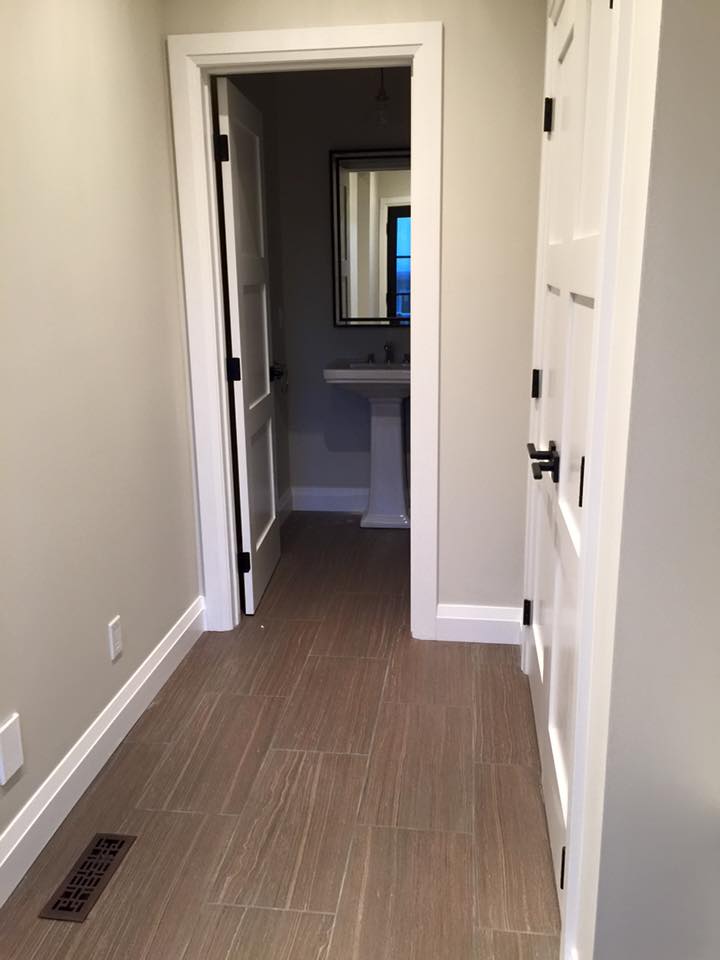 another shot of the mudroom and powder room displaying the tile installed on this project