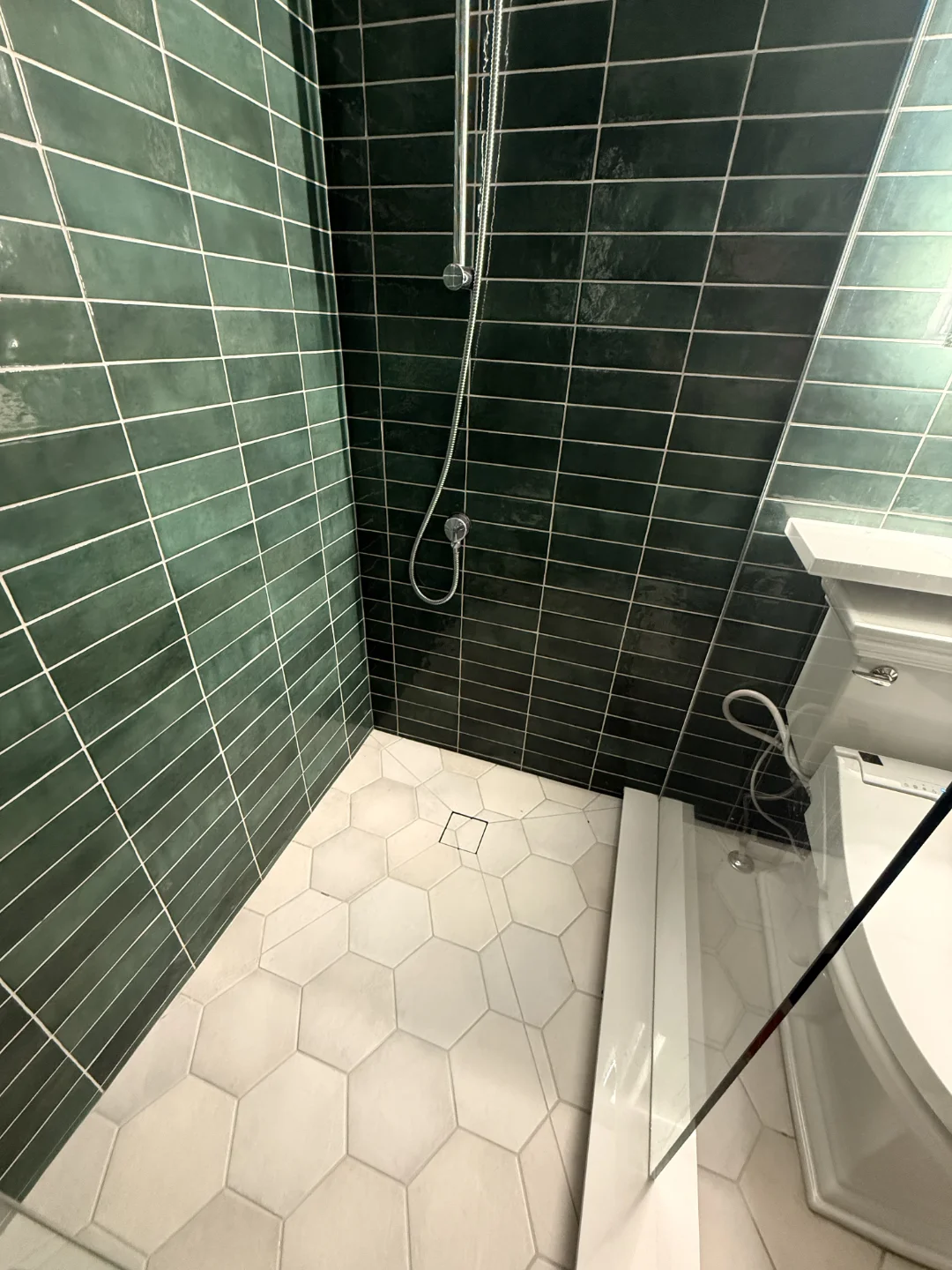 finished bathroom tile renovation in griesbach hexagonal tile floor
